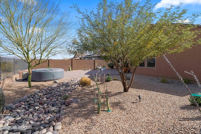 view of yard with a hot tub and a patio