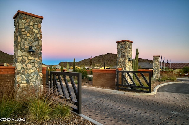 gate at dusk with a mountain view