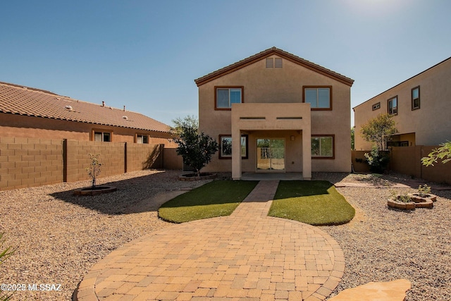 rear view of house featuring a patio