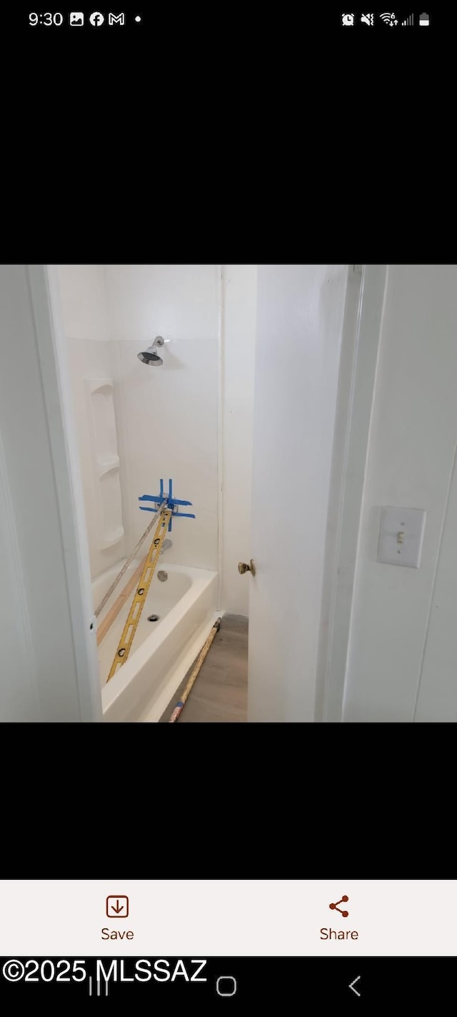 bathroom with bathing tub / shower combination