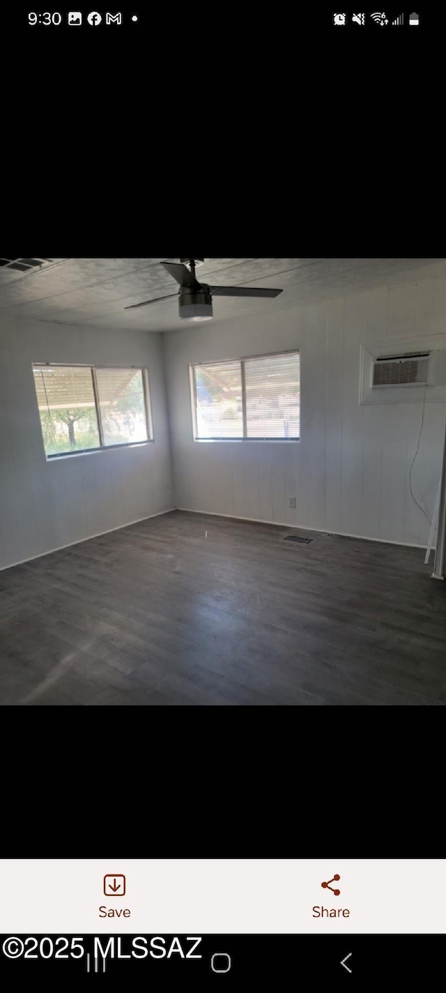 empty room featuring ceiling fan and dark wood-style flooring