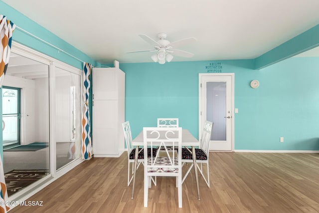 unfurnished dining area featuring hardwood / wood-style flooring and ceiling fan