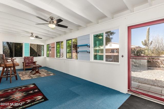 sunroom / solarium featuring beamed ceiling