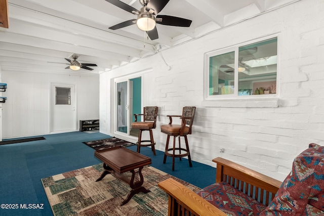 interior space with beamed ceiling and ceiling fan