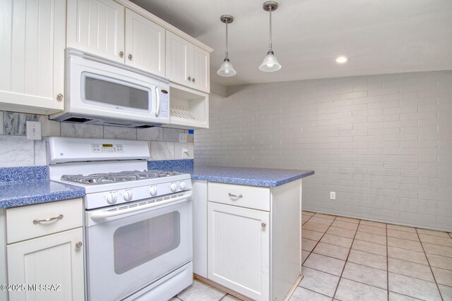 spare room featuring brick wall, lofted ceiling, and light tile patterned floors