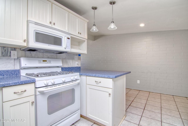 kitchen with white appliances, white cabinetry, decorative backsplash, and light tile patterned floors