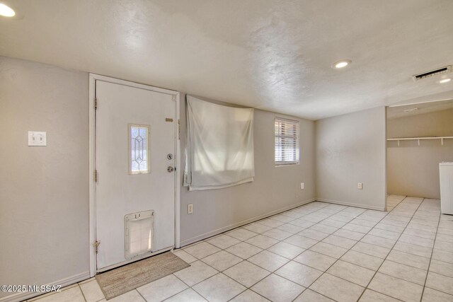 tiled spare room featuring vaulted ceiling and a wealth of natural light