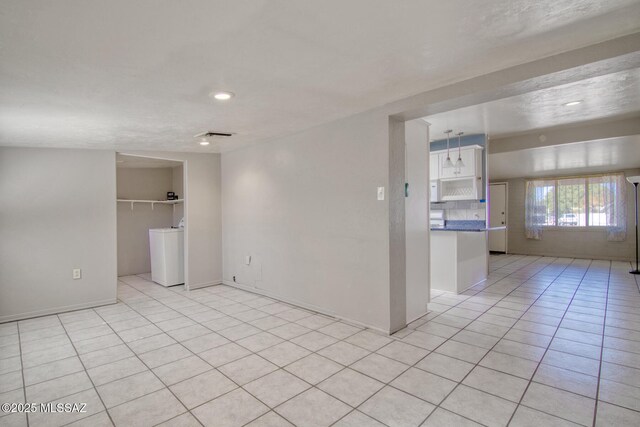 empty room with brick wall and vaulted ceiling with beams