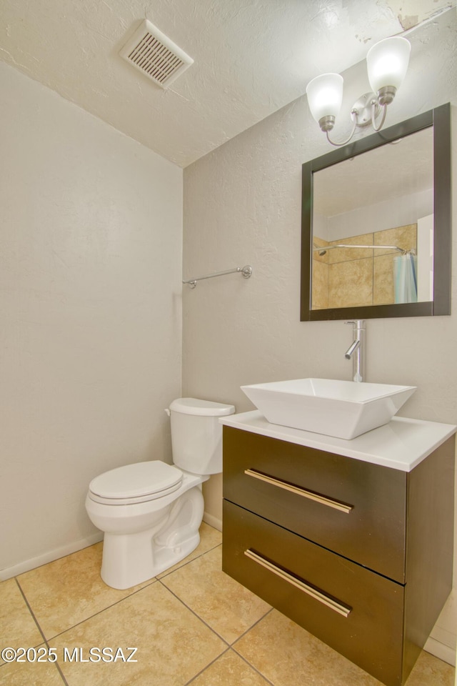bathroom featuring tile patterned floors, toilet, vanity, a shower with curtain, and visible vents