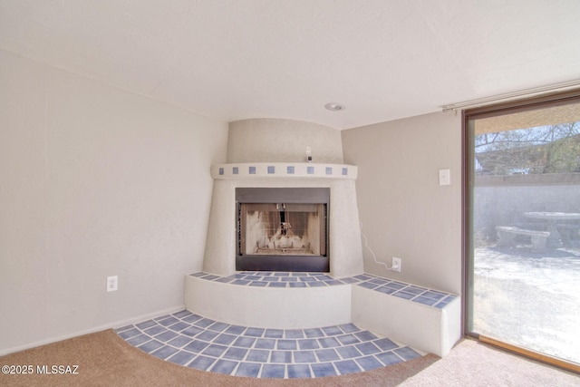 room details with a tile fireplace and carpet flooring