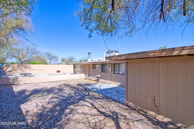 back of house with fence and a patio