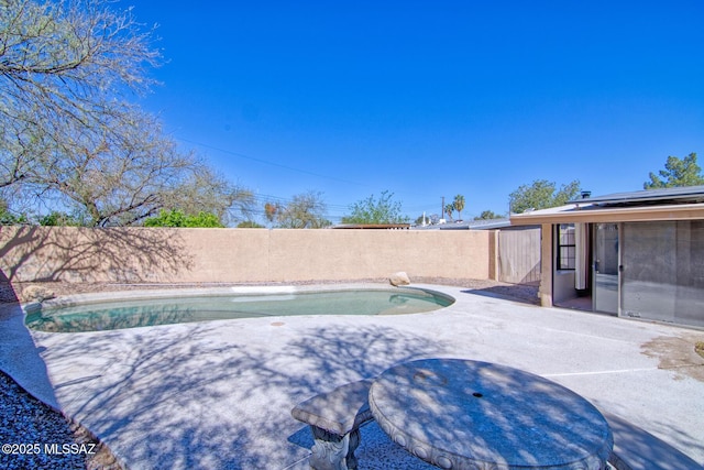 view of pool with a fenced backyard, a fenced in pool, and a patio