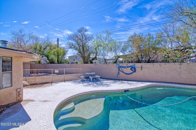 view of swimming pool with fence, a fenced in pool, and a patio area