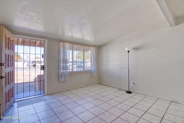 unfurnished sunroom featuring beamed ceiling