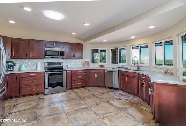 kitchen with stainless steel appliances, sink, and backsplash