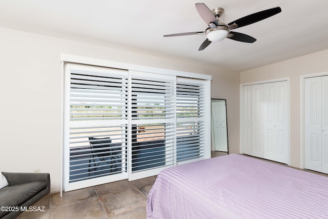 bedroom with ceiling fan and multiple closets