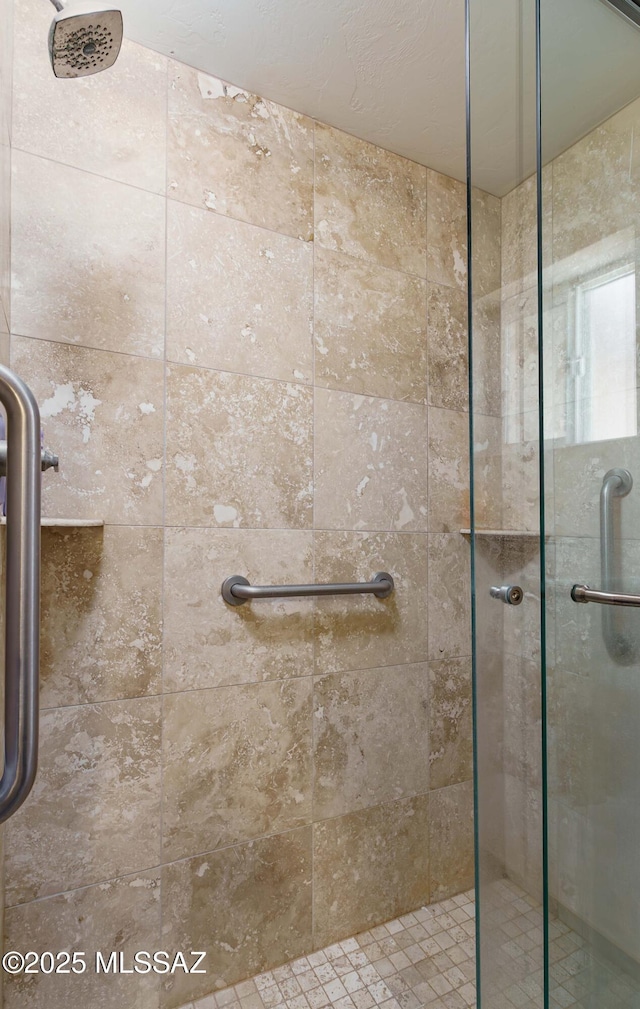 bathroom featuring a shower with door