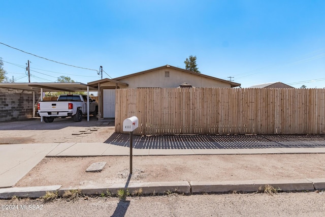 view of side of property featuring a carport