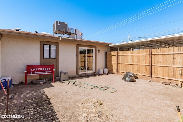 rear view of property with a patio area and central air condition unit