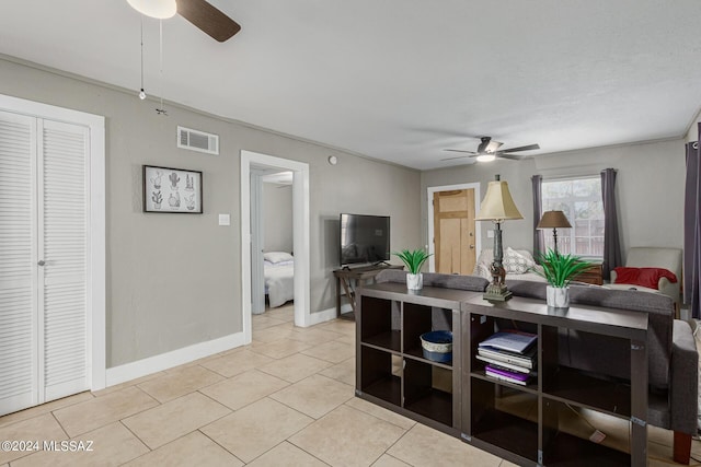 tiled living room featuring ceiling fan