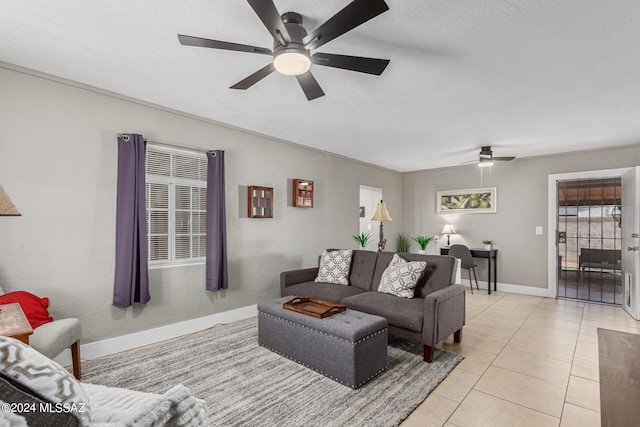 living room with light tile patterned floors, a textured ceiling, and ceiling fan