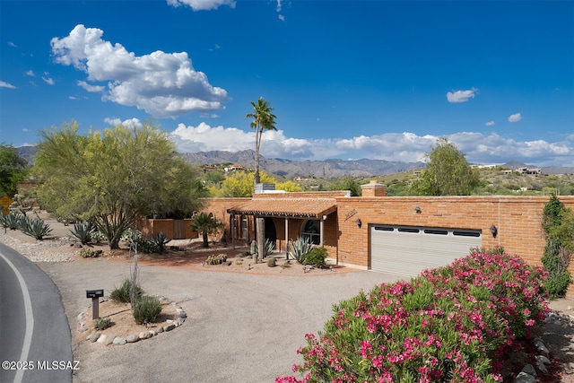 view of front facade with a garage and a mountain view