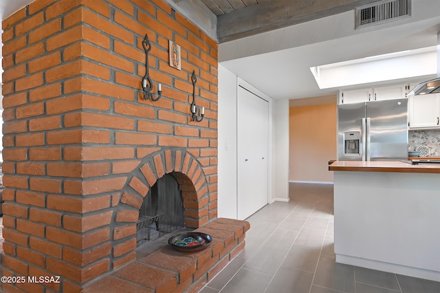 unfurnished living room with a brick fireplace