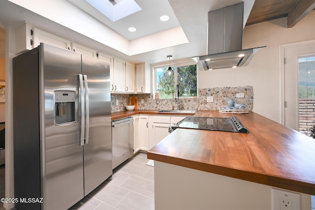 kitchen with sink, white cabinets, decorative backsplash, island exhaust hood, and stainless steel appliances