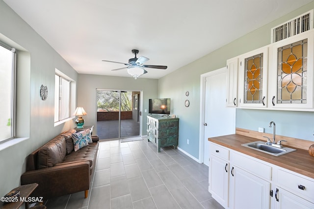 living room featuring sink and ceiling fan