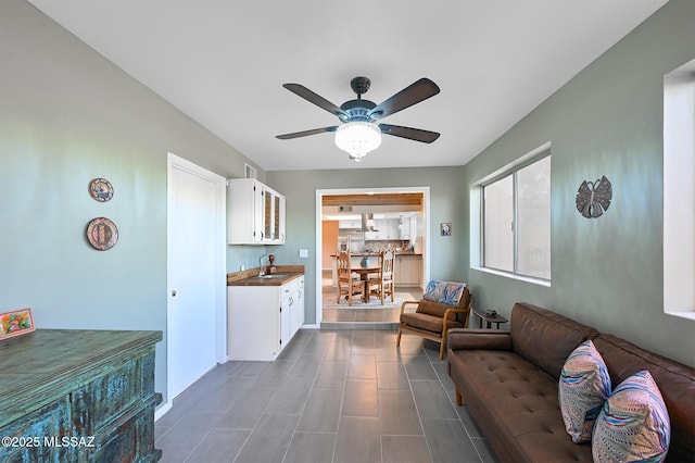 living room with sink and ceiling fan