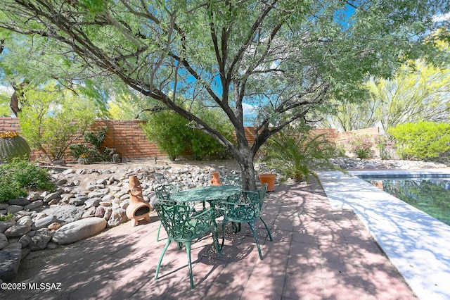 view of patio with exterior fireplace