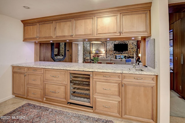 bar featuring light stone counters and beverage cooler