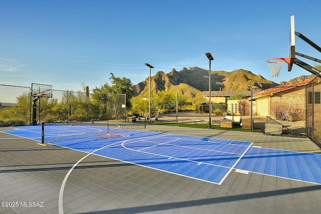 view of basketball court featuring a pergola and a mountain view