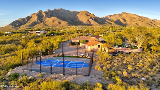 view of sport court with a mountain view and tennis court