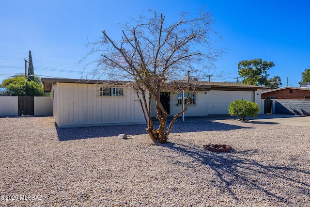 rear view of property featuring a garage