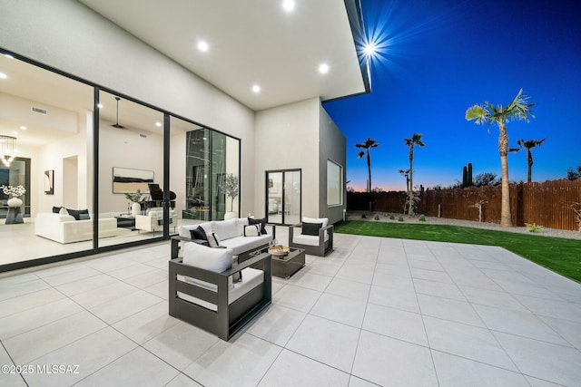 patio terrace at dusk featuring an outdoor hangout area