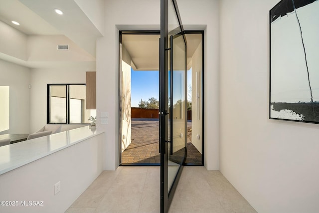 doorway with light tile patterned floors