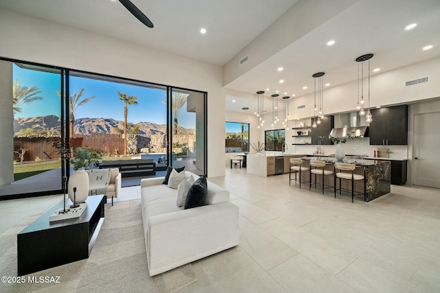 living room featuring a mountain view and a high ceiling