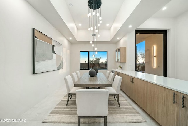 dining area with a raised ceiling