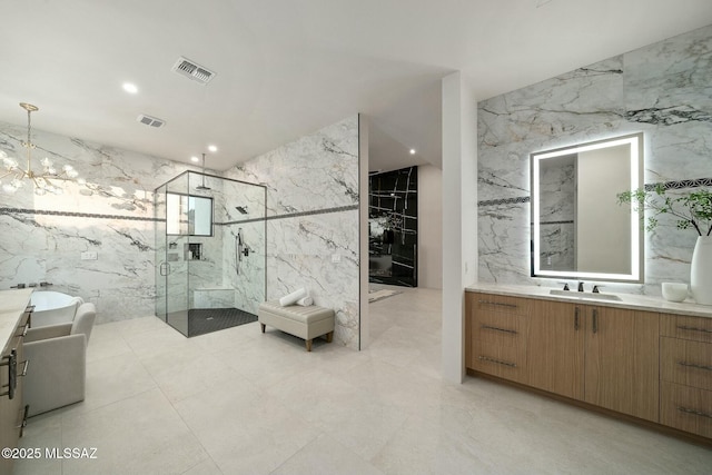 bathroom featuring vanity, shower with separate bathtub, tile walls, and a chandelier