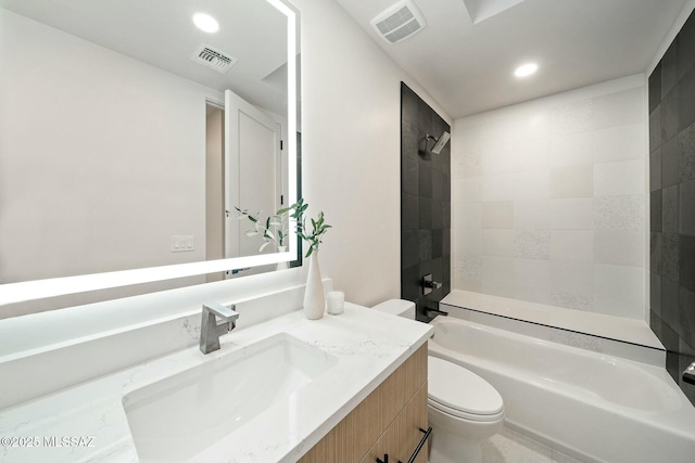 full bathroom featuring vanity, toilet, and tiled shower / bath combo