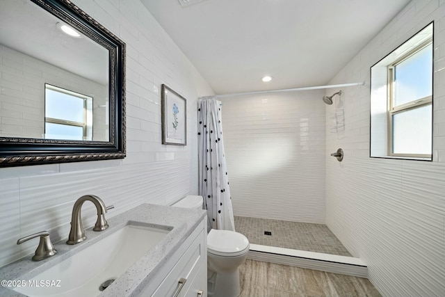 bathroom featuring a wealth of natural light, toilet, tile walls, and a shower with shower curtain