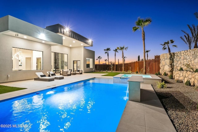 pool at dusk with an outdoor living space, a patio, and an in ground hot tub