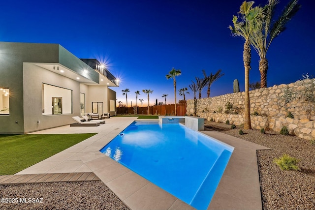 pool at dusk with a patio