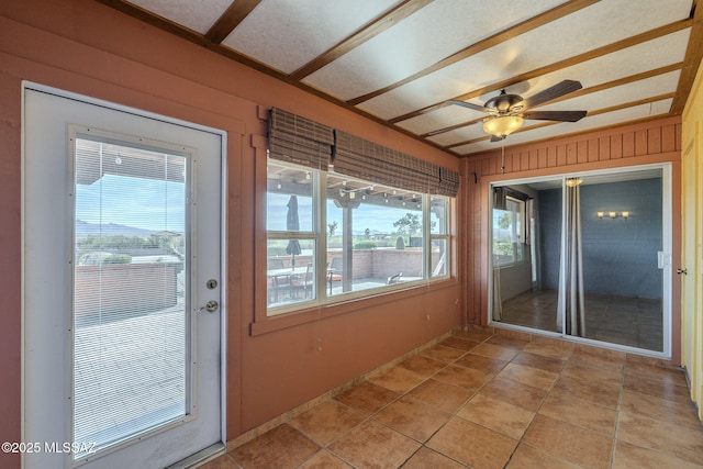 unfurnished sunroom featuring ceiling fan