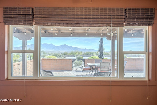 interior details featuring a mountain view and rail lighting