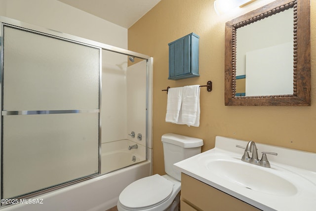 full bathroom with vanity, enclosed tub / shower combo, and toilet