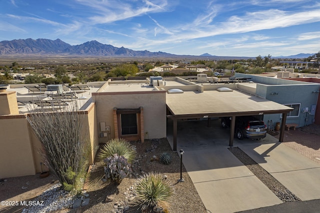 view of front facade featuring a carport and a mountain view