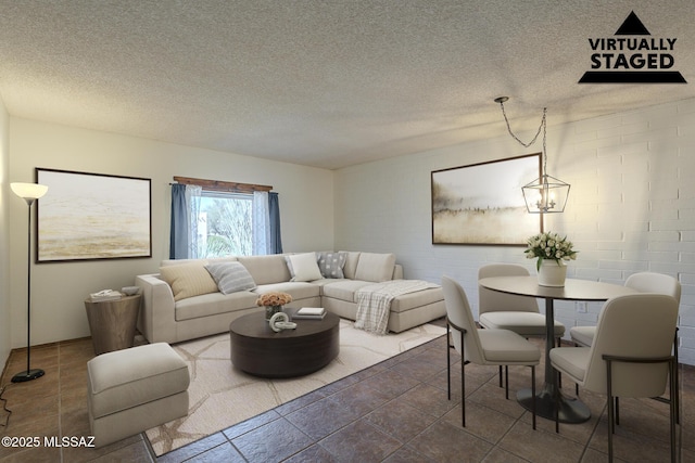 living room featuring a chandelier and a textured ceiling