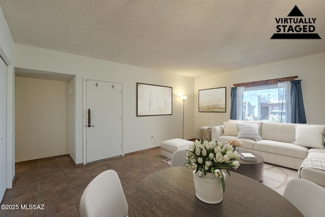 tiled living room with a textured ceiling